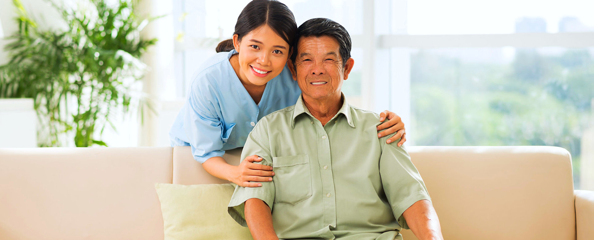 senior man and a caregiver smiling