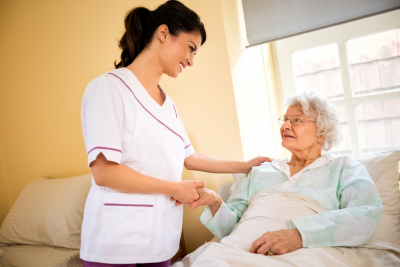 senior woman and caregiver looking at each other