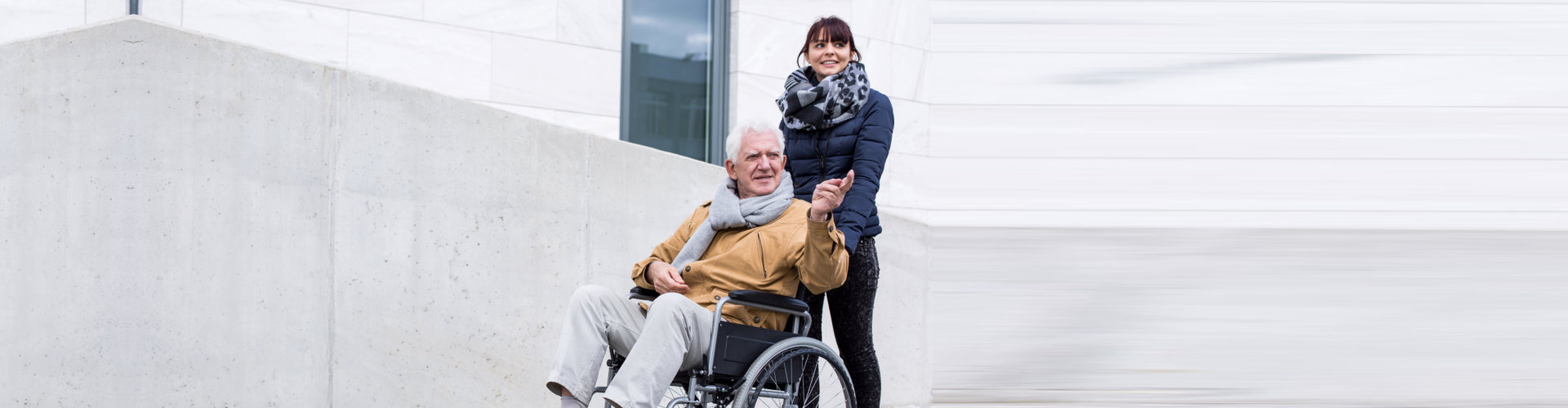 senior man and caregiver looking at something